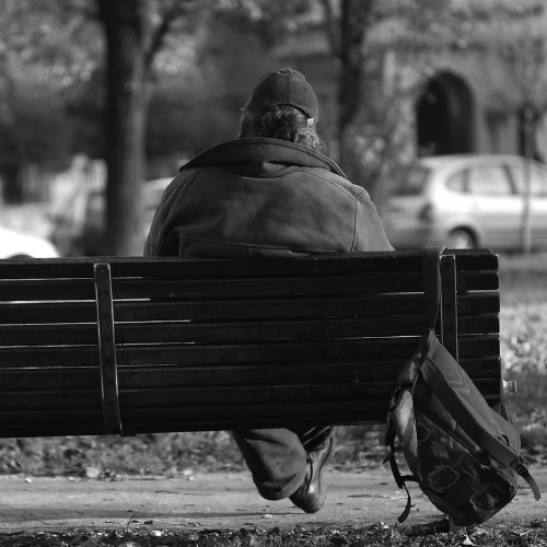 Homeless person sitting on a bench